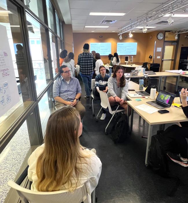 students with professor planning project